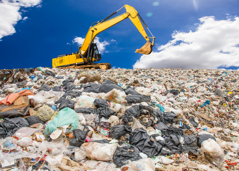 Environmental Impact - Plastic waste landfill with excavator